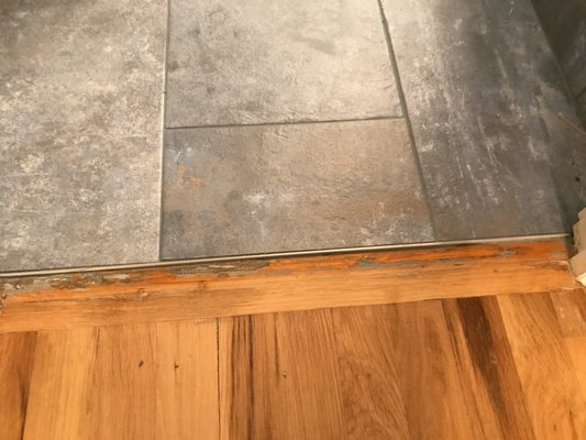 Blue-grey grout left on the wooden floor