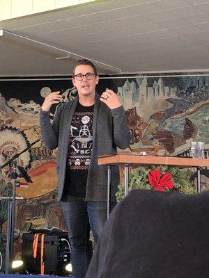 Pastor Chris preaching with his Star Wars shirt on.