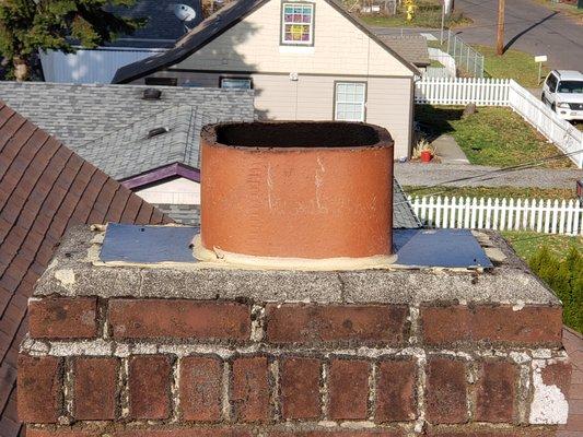 Chimney top with improperly installed flashing and caulk