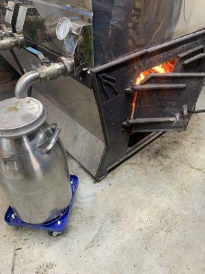 Wood furnace and large container of maple syrup