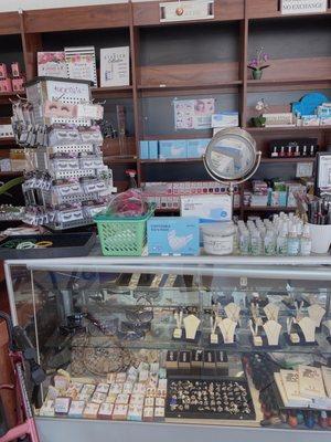 Front counter with lash sets, jewelry, & hand sanitizer