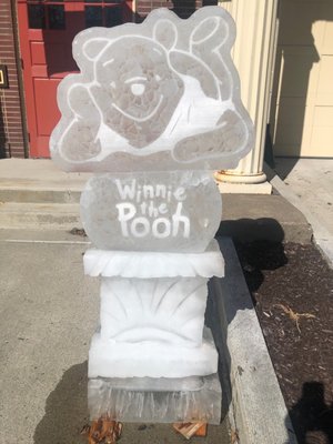 Winnie the Pooh ice sculpture made for cartoon winterfest in front of firehouse.