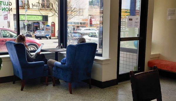 Quaint comfy chairs by the window.