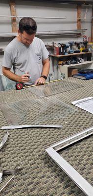 Jeremy cutting some cabinet glass