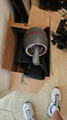 Excercise equipment tossed on top of expensive computer keyboards.