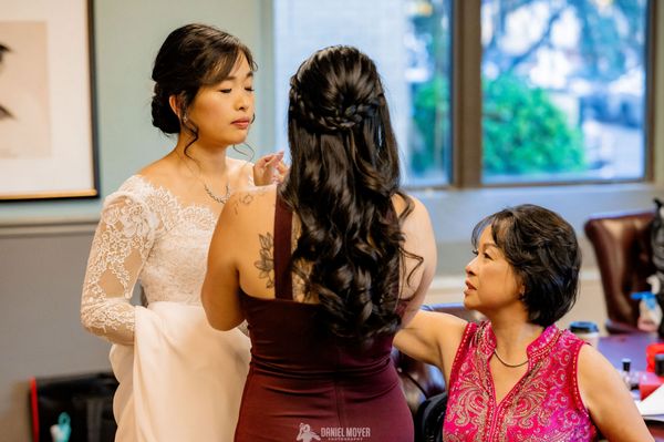 The bride's family helping with makeup touchups