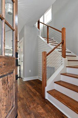 Beautiful mix of modern cable rails and traditional craftsman stairs