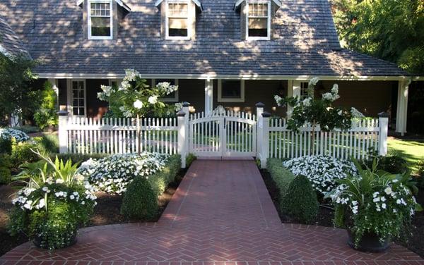 Brick sidewalk and picket fence