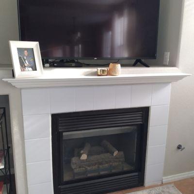 Installation of mantel shelf over fireplace.