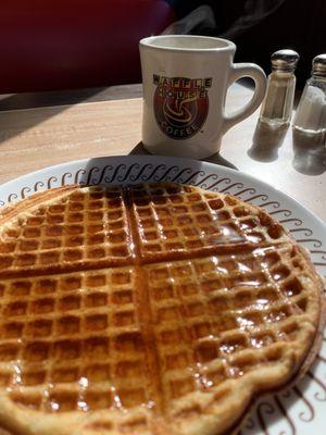 Coffee and waffle covered in syrup