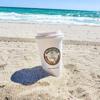 Coffee in the sand with the view of the beach.