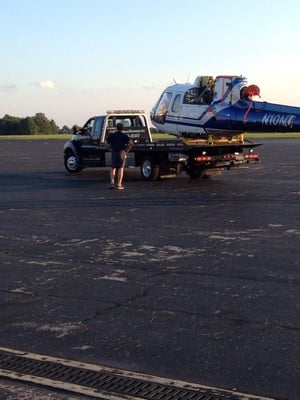 This is J&R towing and recovery llc towing a helicopter at summitt aviation