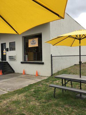 outdoor seating with sunny yellow umbrellas welcomes you!