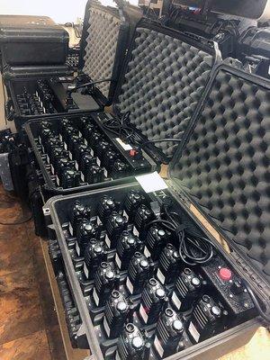 Radios stored in charging cases and ready for rental.