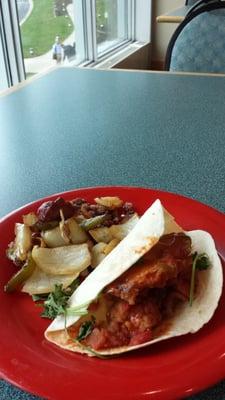 Sausage, peppers, and onion over house-made corned beef hash, and a fish taco!