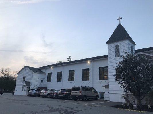 There is an entrance here for the basement hall (by parked car) and a side entrance (see stairs) to the front of the church