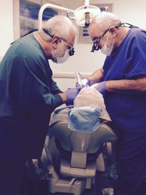 Dr. Paul Shteynberg (left) and Dr. Simon Faynzilberg (right) placing implants