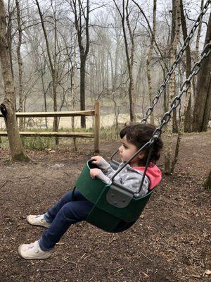 Swinging on the playground with the river close by in the background!