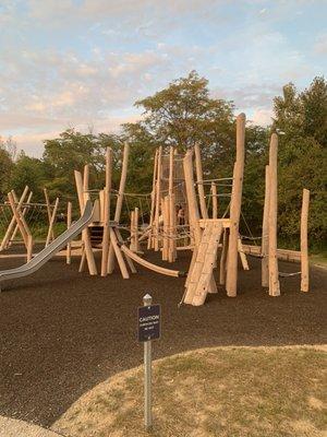 The playground has shredded rubber around the equipment