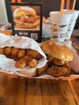 Sandwich box : chicken strip sandwich with bird sauce, tater tots, chips and cup of queso  Not pictured : grilled jalapeño