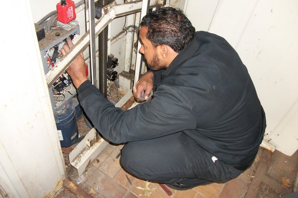 Mechanic servicing a Wheelchair Lift