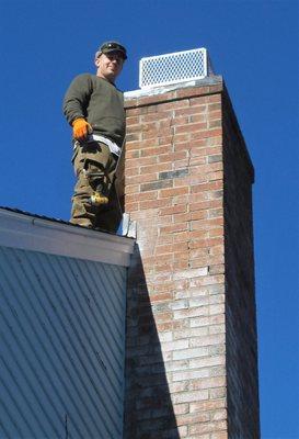 Mal Working On Attaching New Mult-faceted steel framed Protection Chimney Cap.