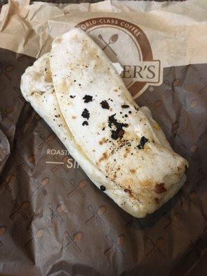 Nasty, charred burrito with a little hair on top.