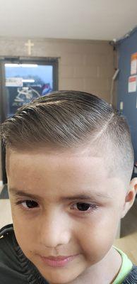 Kids comb over mid fade with hard part