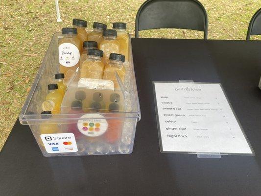 A container of flight packs, ginger shots, and snap in ice at the Islands Farmers Market