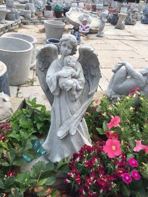 Concrete angel statue holding a baby