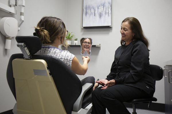 Maria, one of our dental hygienists, with a patient.