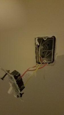 Another outlet with live wires left exposed.