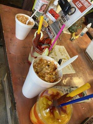 Mango smoothie with tamarind straw, elotes in a cup and some wild candy stuffed beverage babe got.