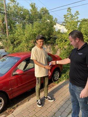 Law Auto salesman Ian handing over the keys to my son's first car.