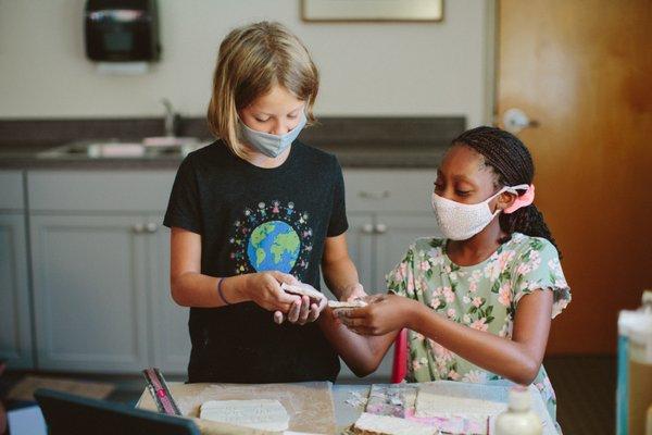 A 5th and 6th grader use clay during a math assignment. Integrating the arts into core curricula is a standard practice in our classrooms.