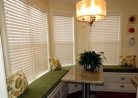 Quality blinds and custom seating make this a cozy kitchen area.