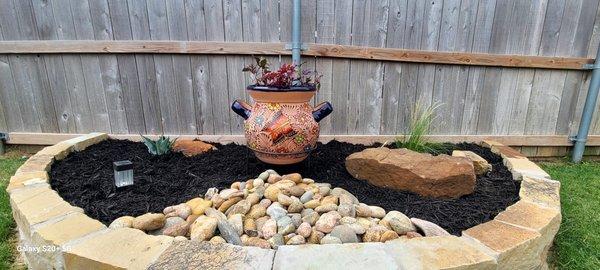 Luder stone border dressed with Colorado coble, a moss boulder and a terracota pot