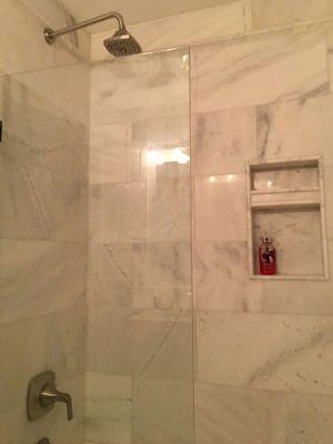 Marble bathroom with a glass partition