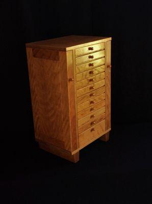 This is a small jewelry tower, made from cherry.