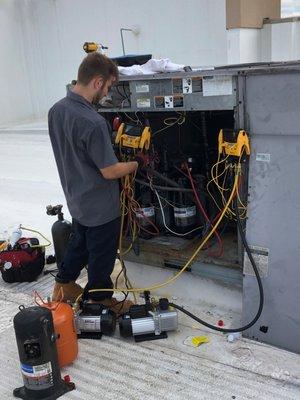 RTU Compressor chg out.    One of our techs working at the Paul Mitchell School.