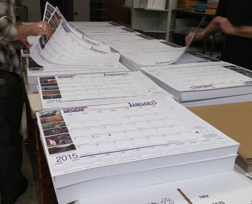 Collating our 2015 desktop calendars.