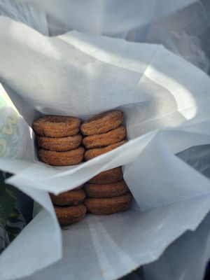 Warm bags of apple cider doughnuts with sugar