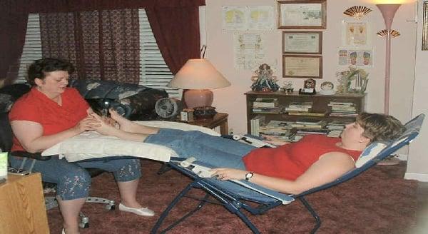 Linda doing Reflexology on a client with Sciatica.