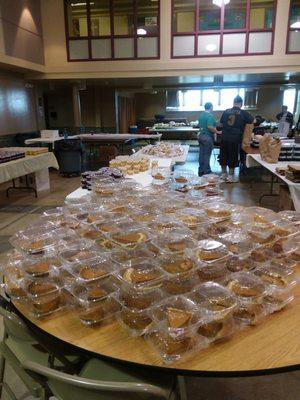 Pies, cranberry sauce, applesauce , rolls, awaiting packing and delivery. Daughter was assigned hauling coolers to cars.