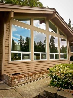 Milgard Style Line Series half-vent under-slider windows and gabled picture windows in white vinyl with new exterior trim