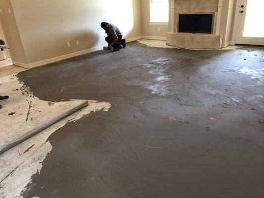 After demo of old flooring, floor leveling was added to prepare for new wood flooring