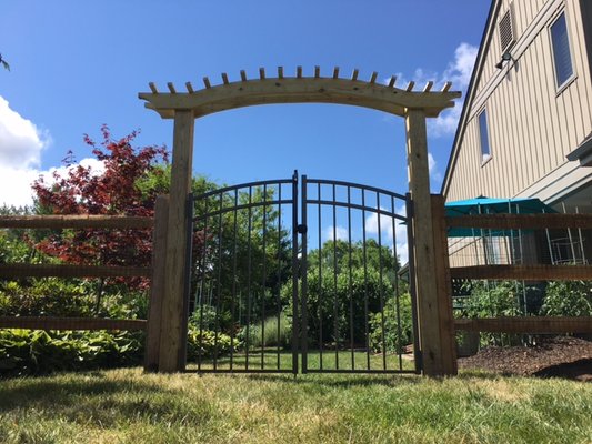 Custom built red cedar arbor with aluminum double gate