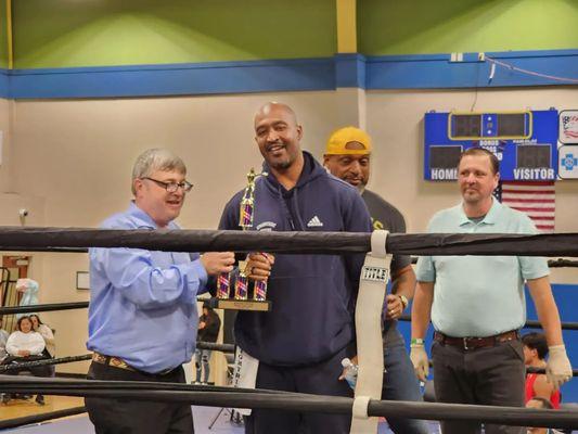 Head Coach Kevin Lightburn and Little Rock Head Coach Anthony Tucker receiving the 2023 Golden Gloves Outstanding Youth Team trophy