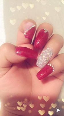 Acrylic nails, red gel polish and Swarovski pixie.