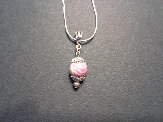 Pendant made from white & pink flower petals.